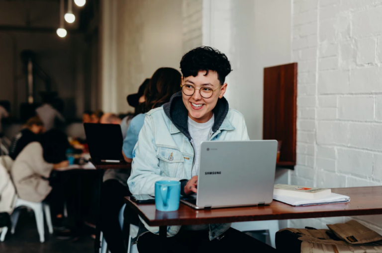 a woman on a laptop at a cafe learning how to optimize her portfolio site