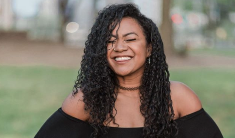 Close up of a woman smiling with her eyes closed.