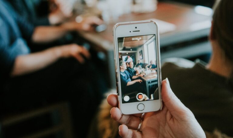 someone holding a phone taking an instagram video of a group of people