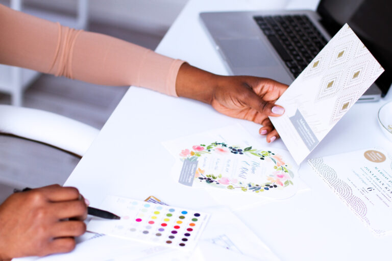 Close up of a woman's hands working with colorful stationary