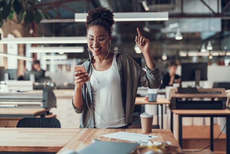 a woman on her phone learning how to write copy to win more clients via email