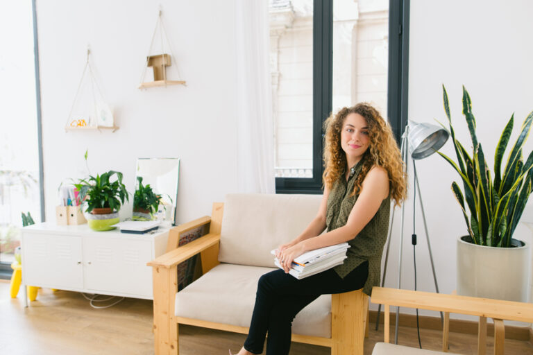 Freelancer sitting on chair with laptop