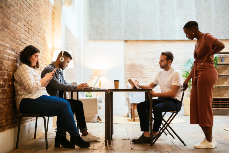 A group of people work around a table.