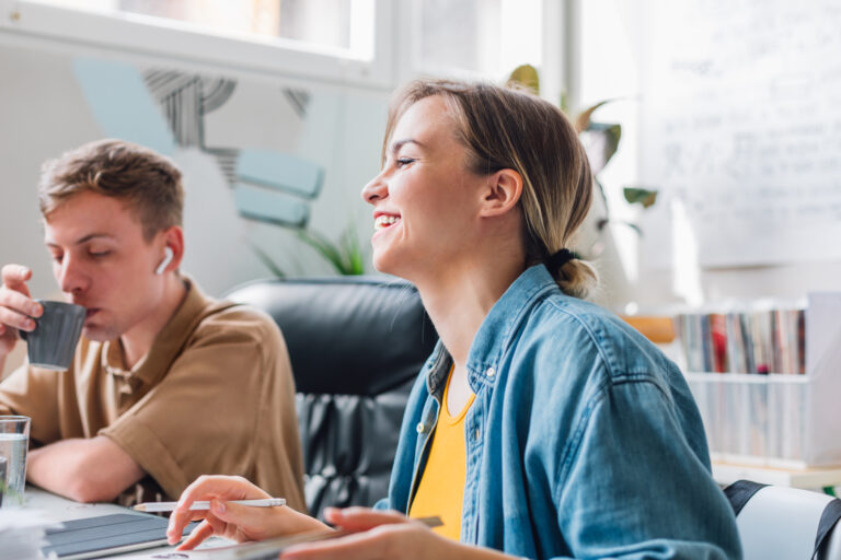 a man and woman at laptops learning 4 things business owners love to automate