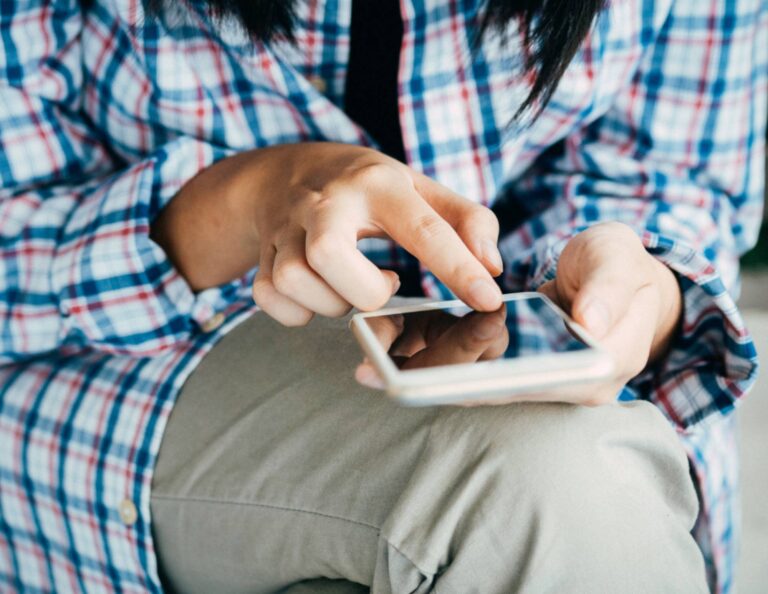 Person designing a brochure on a phone