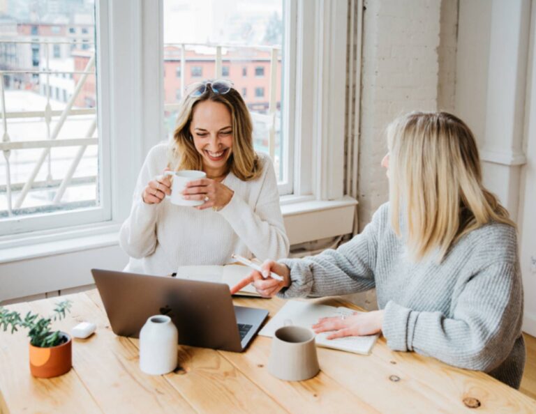 Two women chatting after setting boundaries between business and client