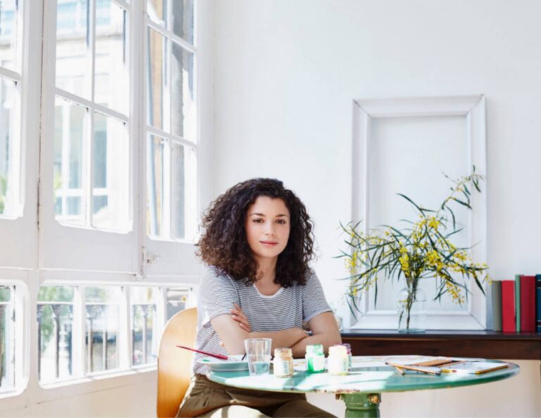 A black woman sitting at a desk practicing work-life integration