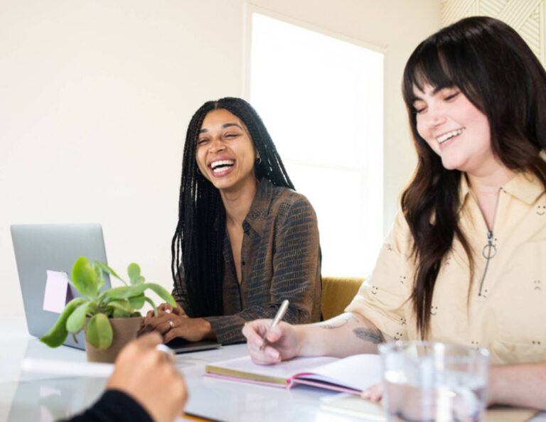 Group of women sitting at a table smiling