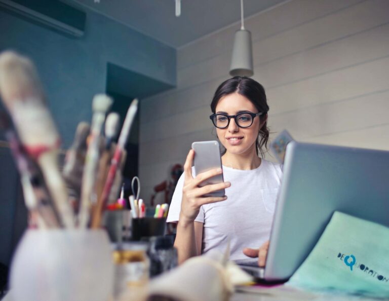 Woman stares at iPhone while working with a happy client.