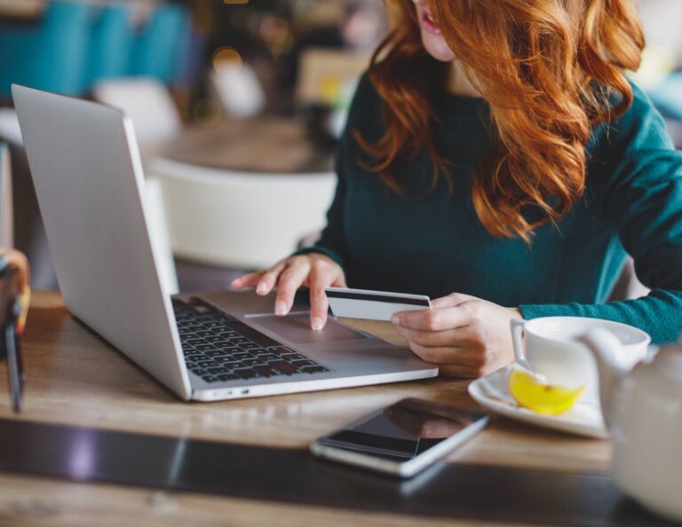 Woman entering credit card information on a laptop