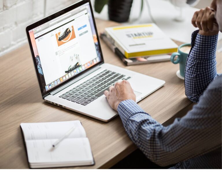 Man at computer reviewing sales tools for business