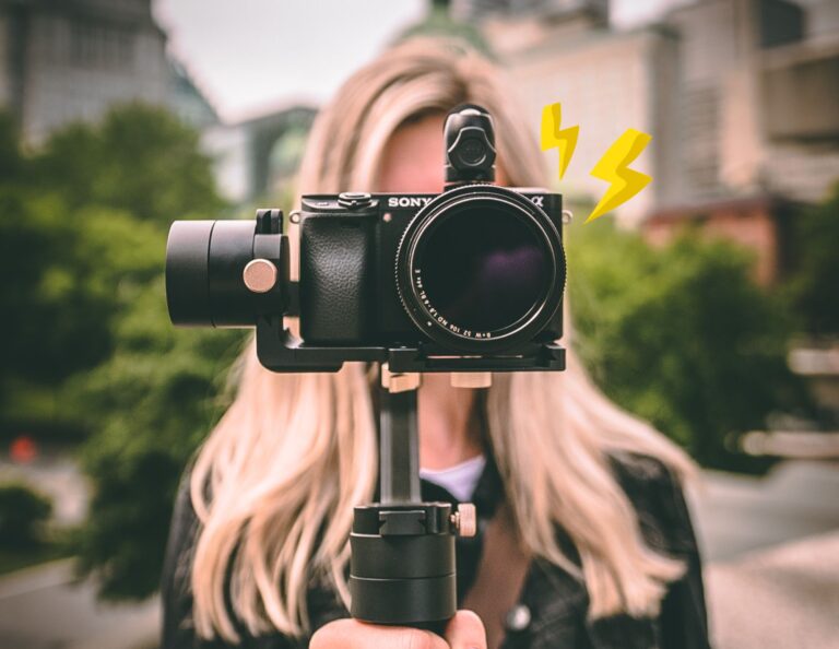 Person looks through camera filing footage for video marketing.