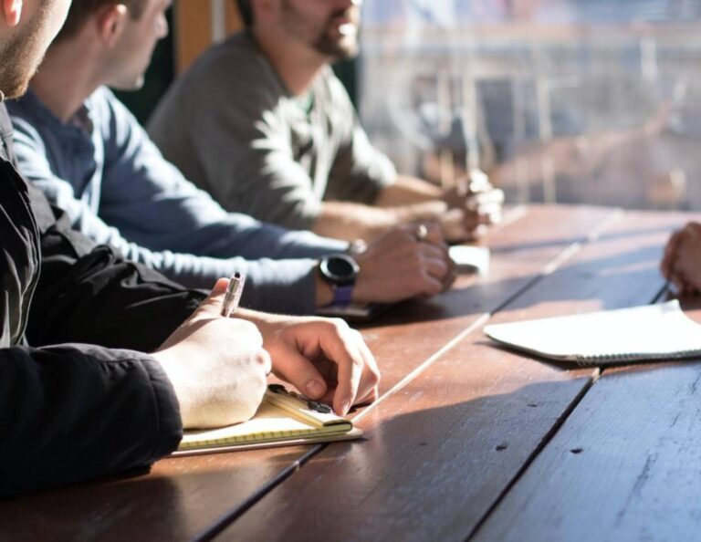 Group of people sitting around a table for a client meeting