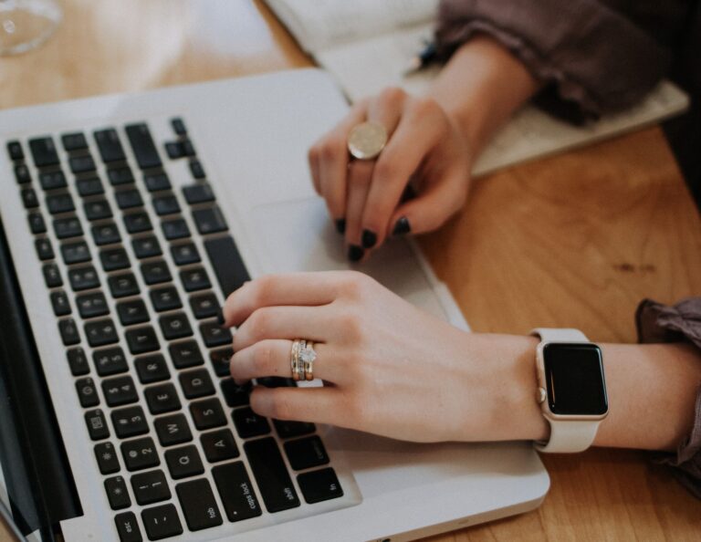 Woman types on a keyboard.