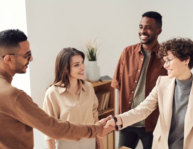 Group shaking hands after an assumptive close