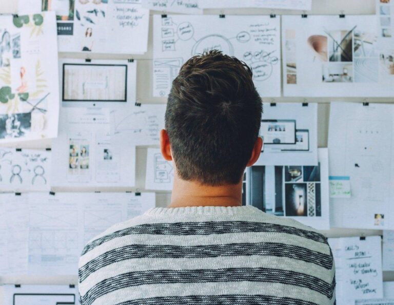 Man creating a business growth plan with a pin board